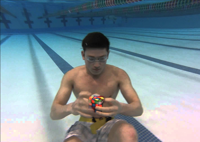 Look At This Guy Solving 3 Rubik's Cubes Underwater