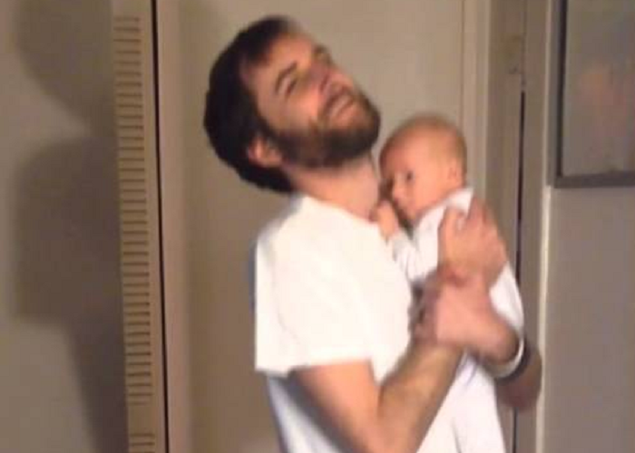 Watch This Guy As He Wears Pants With A Baby In Hand